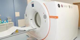 Close up image of the scanner with logos on the side for NPIP and the Universities of Edinburgh and Glasgow