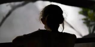 Grey silhouette of a young child against a grey background