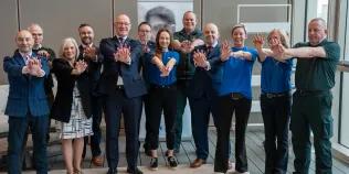 First Minister of Scotland John Swinney poses with a host of people at the announcement of £2.5 million into new defibrillators across the country