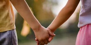 Two children's hands clasped