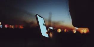 Abstract of a young person using a phone
