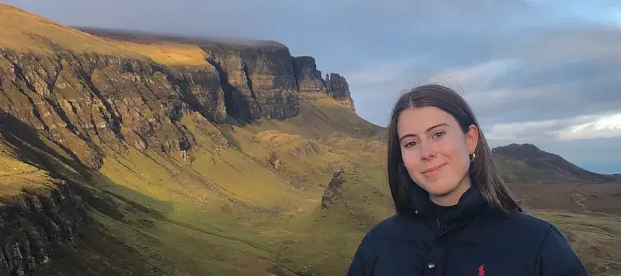 Eva standing in front of a mountian in scotland