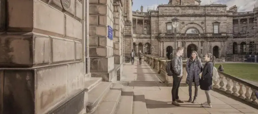 Group of students walking in University of Edinburgh Old College Quad