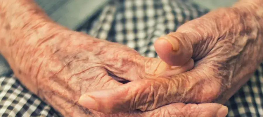 Aged hands on a lap