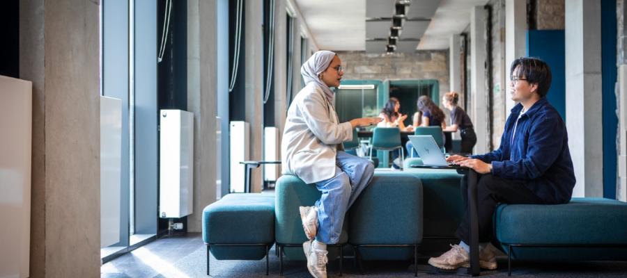 Two young people in conversation at the Edinburgh Futures Institute.