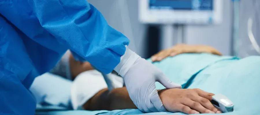 Patient on bed, doctor taking pulse