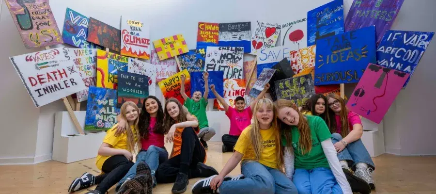 A group of young people from the Children's Parliament post with their artwork in the Talbot Rice Gallery.