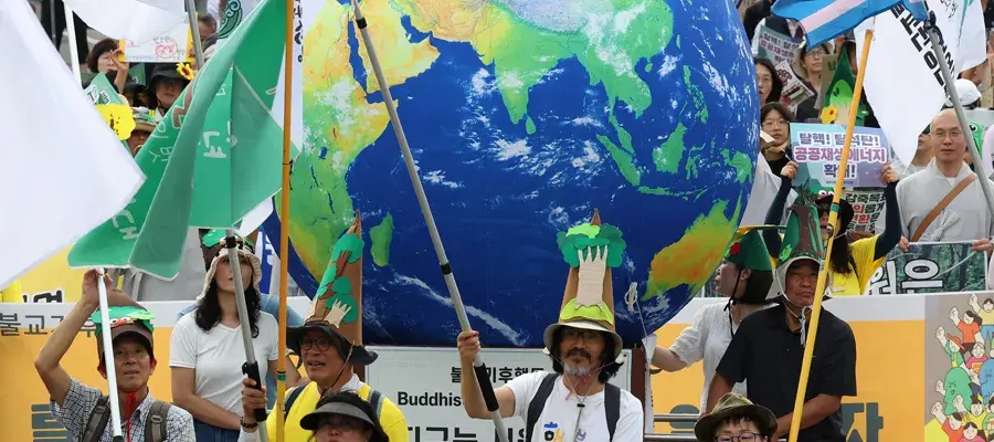 Group of people walking at a march holding flags