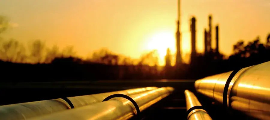 Sunset with oil pipes refinery in background