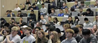 A lecture theatre full of students seen from the point of view of a lecturer