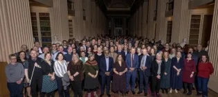 Principal stands in Playfair Library with the colleagues who joined him for the long service awards