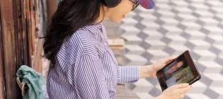 Woman studies on tablet in Malaysian street
