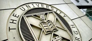 Image of the University's roundel on the side of a building