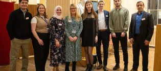 A group of students and university team members at the Education Beyond Borders celebration event.