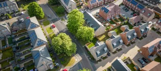 Aerial view of a modern housing development with solar panels installed on all the rooftops