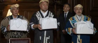 Mr Okawa Masaru, Executive Director, Ainu Association of Hokkaido with Tetsuya Ogawa and Yoshiyuki Uji holding the skulls during the formal repatriation ceremony