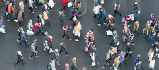 Aerial view of a crowd of pedestrians crossing a street in central Edinburgh