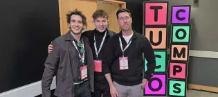 Three men pose for a photograph together at the TUCO 2025 competition.