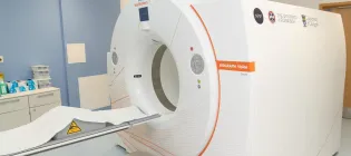 Close up image of the scanner with logos on the side for NPIP and the Universities of Edinburgh and Glasgow