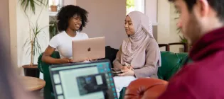 Students in a residential setting, using their laptops