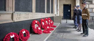 Members of the British Armed Forces pay respect at the War Memorial in the Old College Quadrangle, Edinburgh