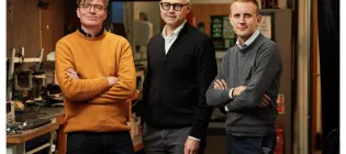 Three professors standing in fire lab
