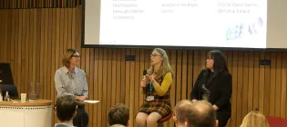 Picture of three women on a panel in front of an audience at an IBM event. Liz McAreavey is host, with Ruth King and Sharon Moore being questioned.