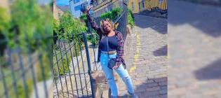 Maria smiling and posing on the street in Edinburgh sunny day
