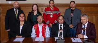 Back Row (L-R): MCN Press Secretary Jason Salsman, MCN Cultural Technician Abigail Dairaghi, MCN Ambassador Jonodev Chaudhuri, MCN Deputy Secretary of Culture & Humanities Anthony Beaver.  Front Row (L-R): MCN Secretary of Culture & Humanities RaeLynn Butler, Second Chief Duck Creek Ceremonial Ground Scott Stafford, MCN Principal Chief David Hill and University of Edinburgh Principal Professor Sir Peter Mathieson. 