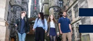 Four students walking at New College.