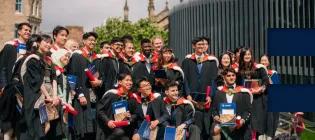 A group of graduates smiling for a photograph.