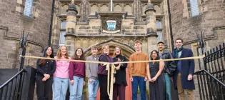 A group featuring students and staff from the University open Teviot with a ribbon-cutting moment.