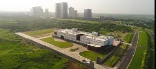 Aerial view of GBU, showing a city skyline with high skyscrapers in the background