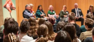 image from the back of an audience of school pupils at a hustings event with councillors from across Edinburgh