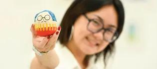 Image of ECA graduating student Tiana Sung with a figure