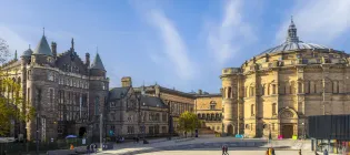 An exterior view across Bristo Square featuring McEwan Hall and the Teviot. 