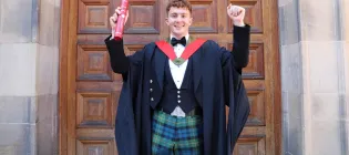 Archie Goodburn photographed outside McEwan Hall with his degree certificate