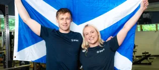 Commonwealth Games medallists, Paraswimmers Stephen Clegg MBE and Faye Rogers pictured in the University performance gym holding a Scottish flag