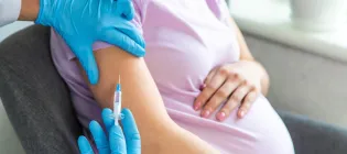 Close up of pregnant woman receiving vaccination
