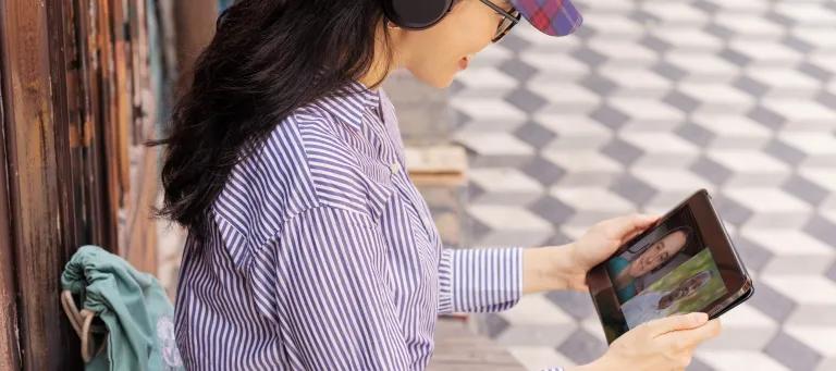 Woman studies on tablet in Malaysian street