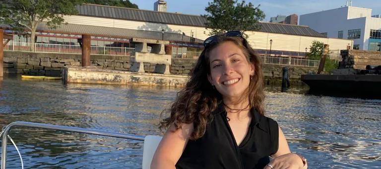 lauren sits on a boat on the water