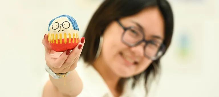 Image of ECA graduating student Tiana Sung with a figure