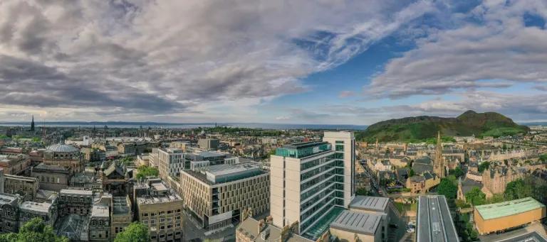 Drone image of George Square buildings, with Appleton Tower in the foreground, 40 George Square to the far right and Arthur's Seat in background.