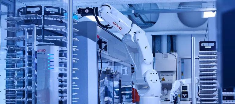 A robotic arm moving through an automated lab.