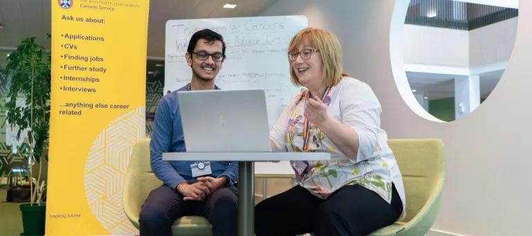 Career Consultant talking to student with laptop