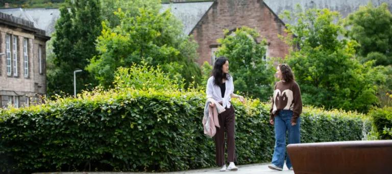 two students walk around Moray House