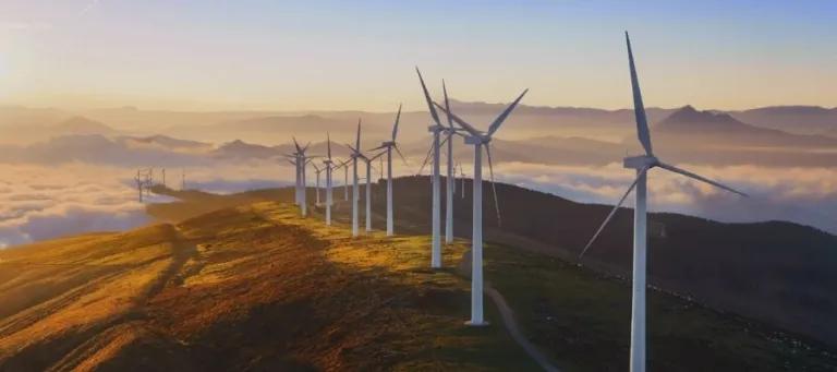 Windmills on a grassy hill.