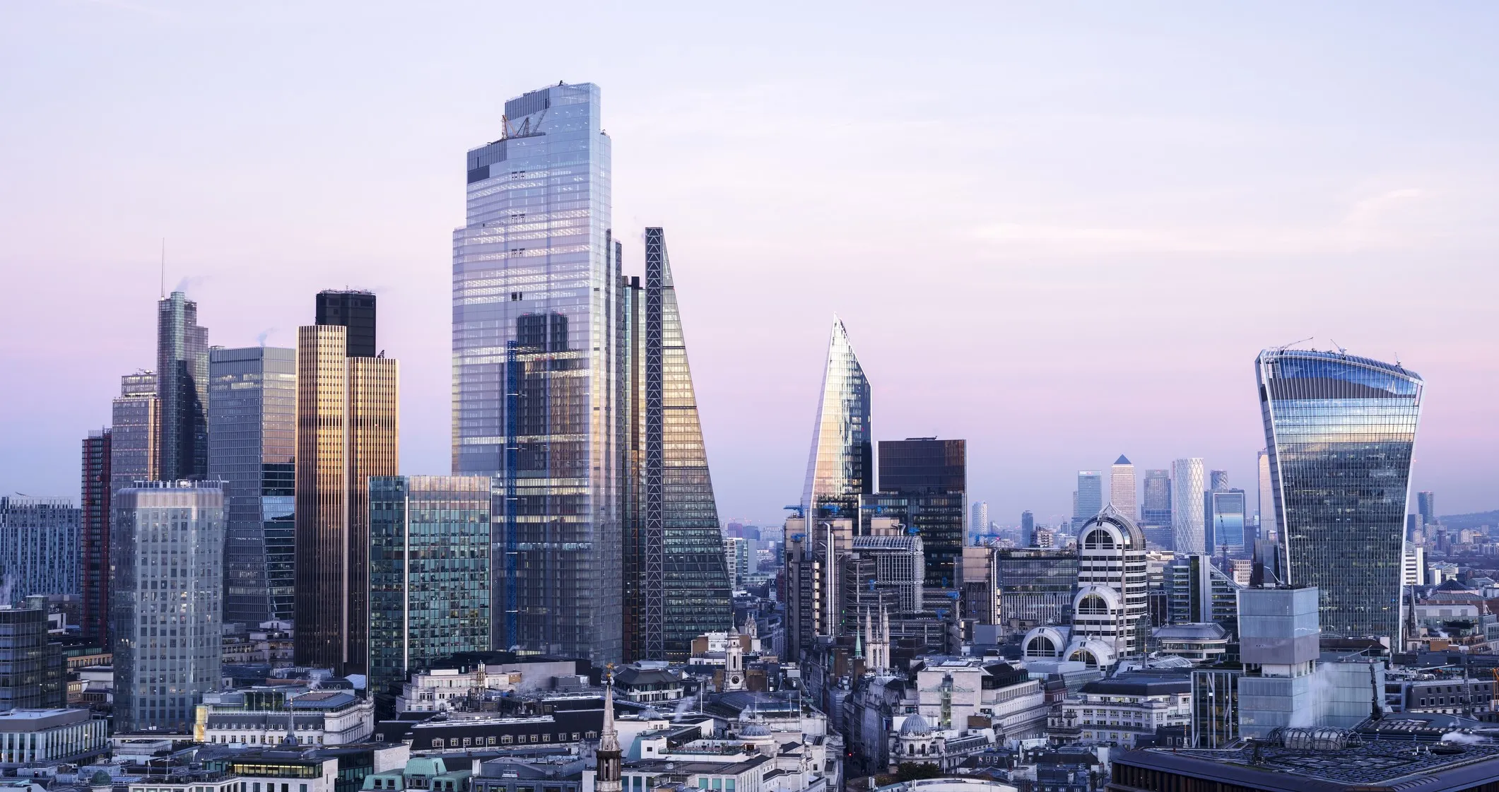 looking East with view of the financial district and Canary Wharf in London, UK, against sky at dusk