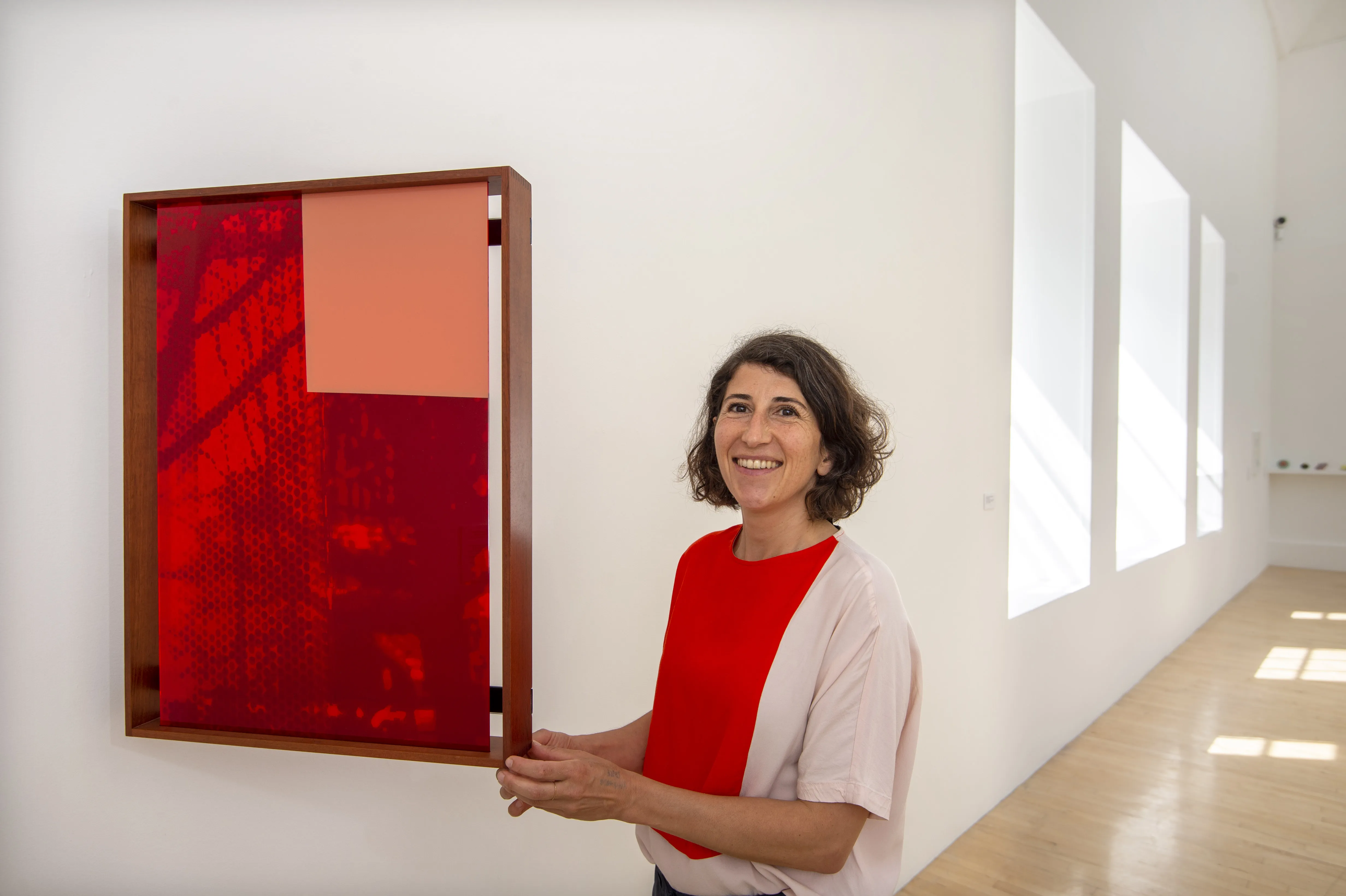 Artist next to painting in Gallery