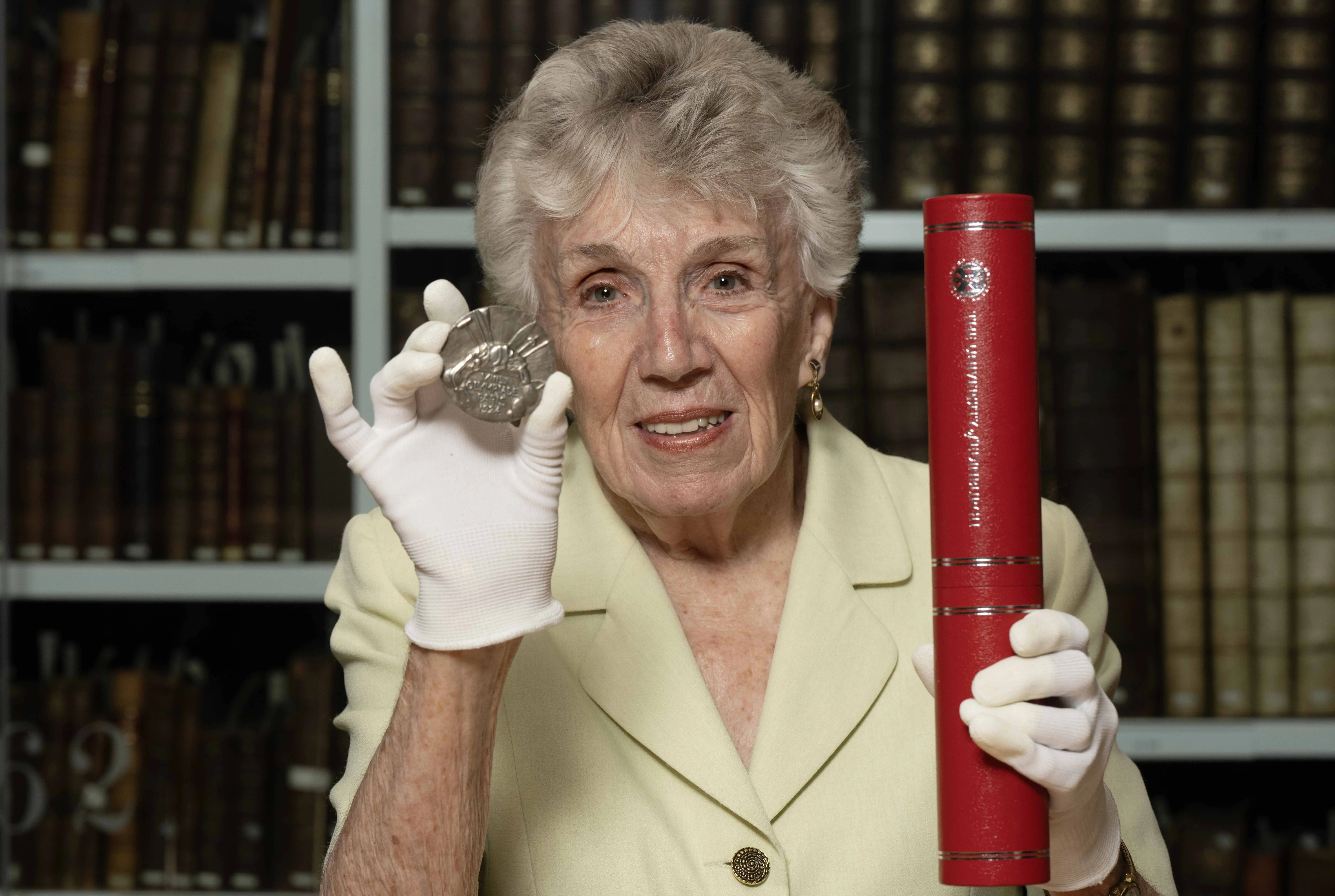 Patricia Liddell Russell holds her father Eric Liddell's honorary degree and Olympic gold medal 